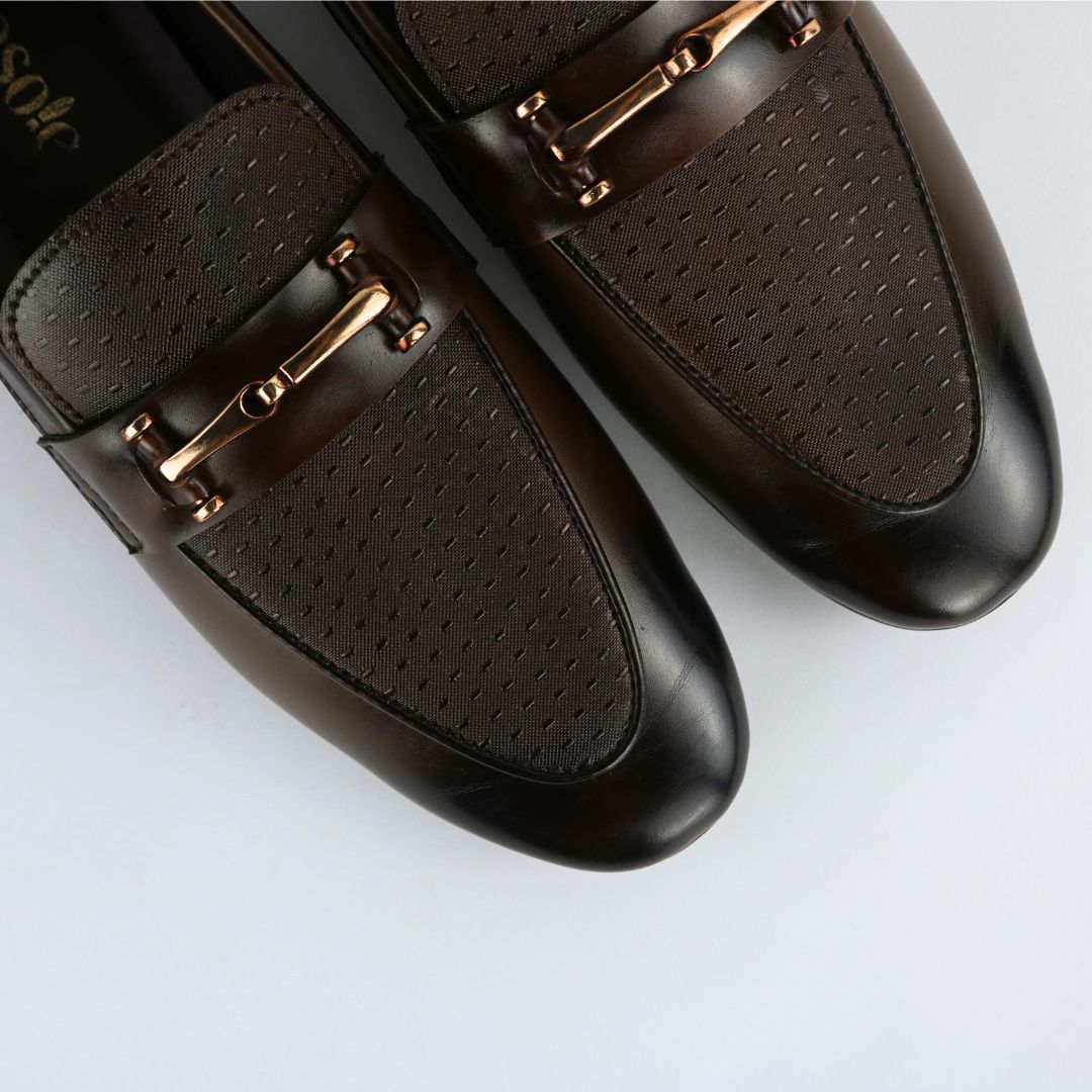 Pair of brown formals with gold accents on a light gray background