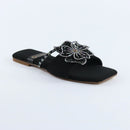Black sandal with decorative flower on a white background topmanshoes