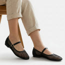 Noir Ballet Pumps  worn with beige pants on a white background